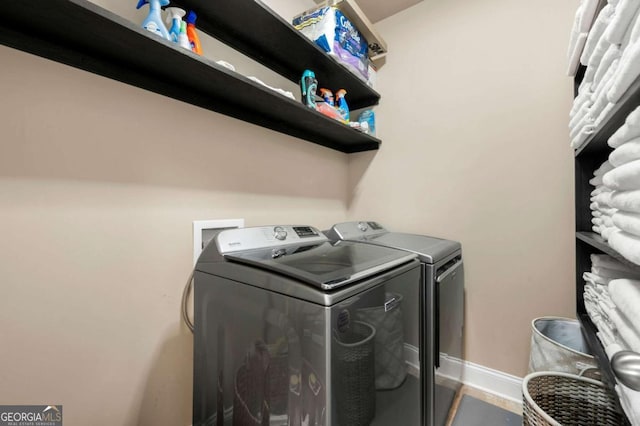3755 Lake Haven Way, Atlanta, GA 30349 - washroom featuring washing machine and clothes dryer and baseboards