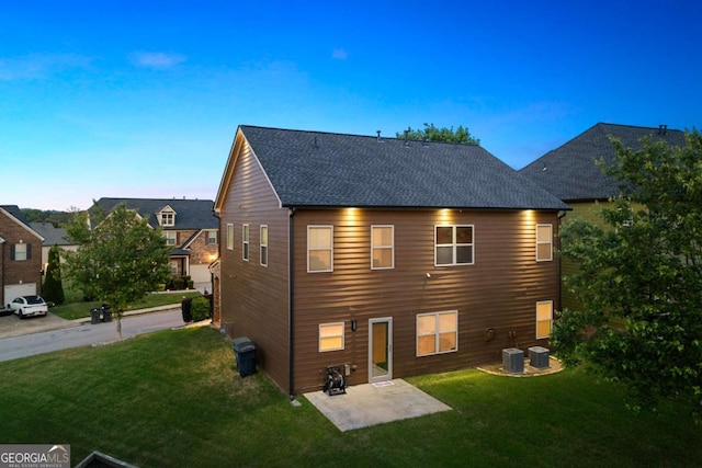 3755 Lake Haven Way, Atlanta, GA 30349 - back of house at dusk with a yard, a patio, and central air condition unit
