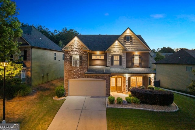 3755 Lake Haven Way, Atlanta, GA 30349 - view of front facade featuring stone siding, driveway, a front lawn, a garage, and brick siding