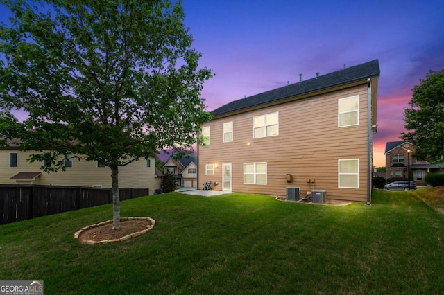 3755 Lake Haven Way, Atlanta, GA 30349 - back of property at dusk featuring a patio area and central AC unit