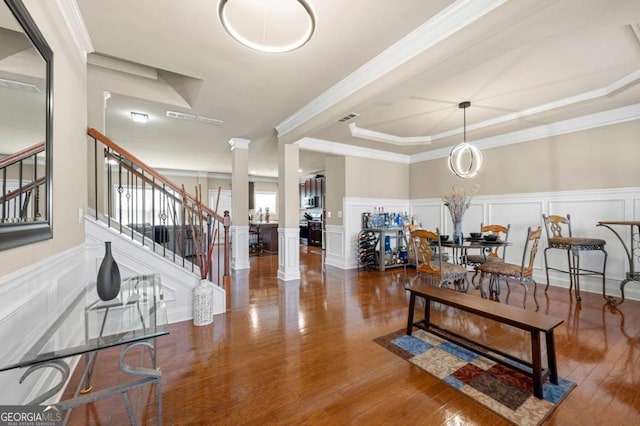 3755 Lake Haven Way, Atlanta, GA 30349 - living area featuring decorative columns, a decorative wall, stairway, wood finished floors, and a raised ceiling
