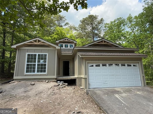 view of front of home featuring a garage and aphalt driveway