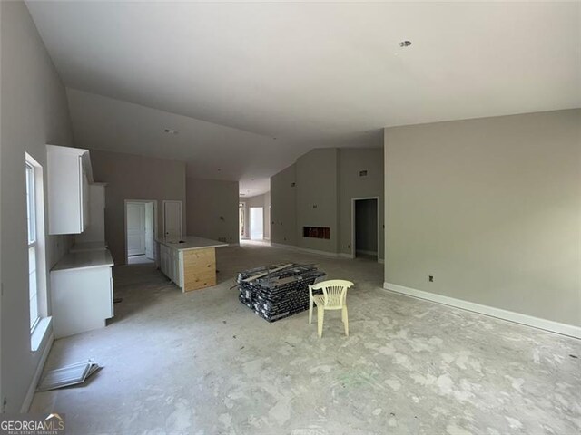 unfurnished living room with vaulted ceiling