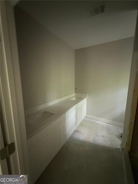 interior space featuring baseboards and visible vents