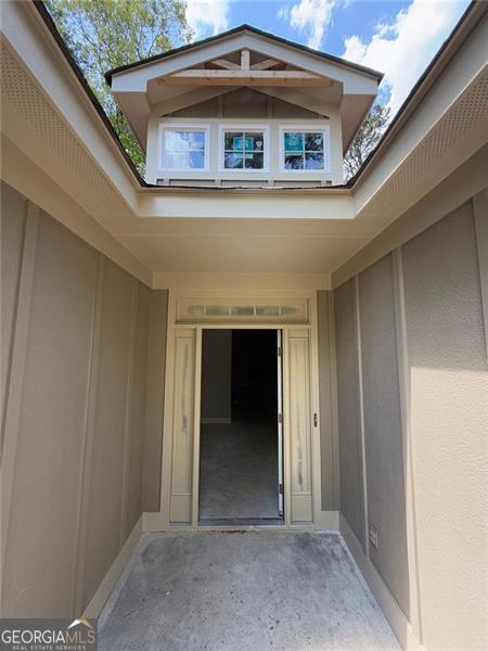 property entrance featuring a patio area