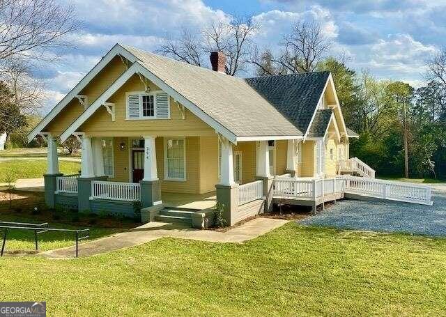 394 Broad St, Milledgeville, GA 31062 - back of house featuring a lawn, a chimney, and a porch