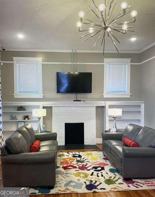 394 Broad St, Milledgeville, GA 31062 - living room with crown molding, a brick fireplace, wood finished floors, a textured ceiling, and a chandelier