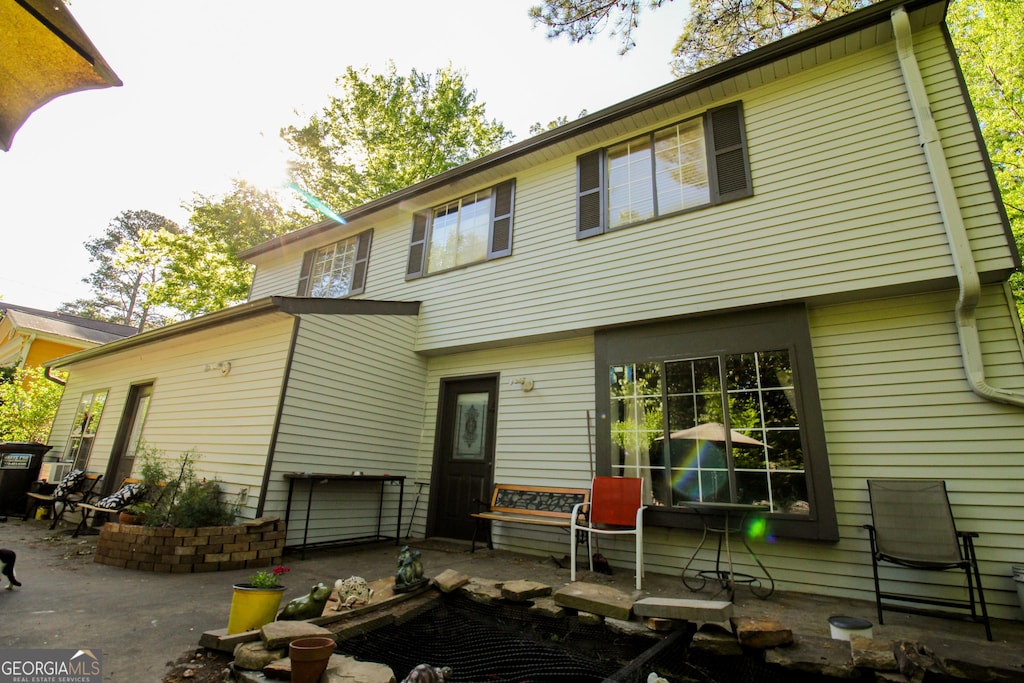 back of property with a patio
