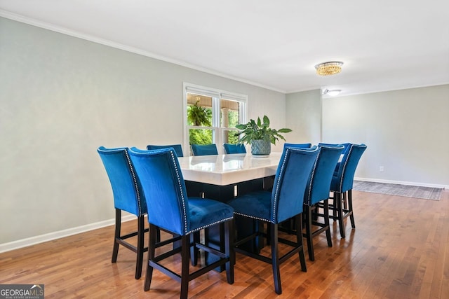 3415 Trickum Rd, Woodstock, GA 30188 - dining space featuring crown molding, wood finished floors, and baseboards
