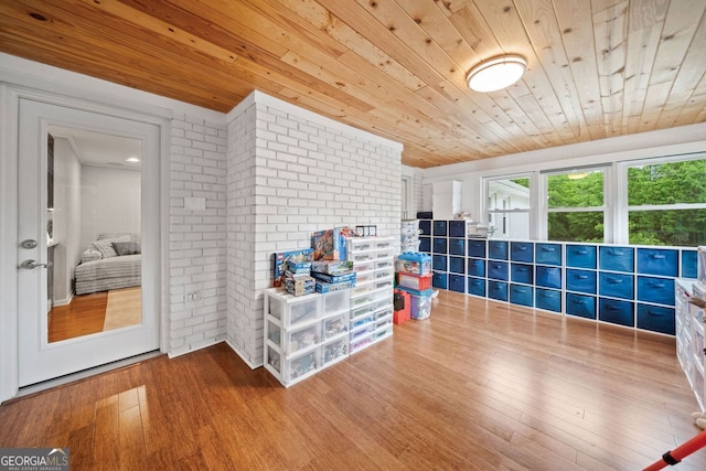 3415 Trickum Rd, Woodstock, GA 30188 - recreation room with wood ceiling, wood finished floors, and brick wall