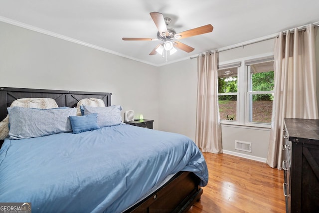3415 Trickum Rd, Woodstock, GA 30188 - bedroom with light wood-style floors, baseboards, ornamental molding, and ceiling fan