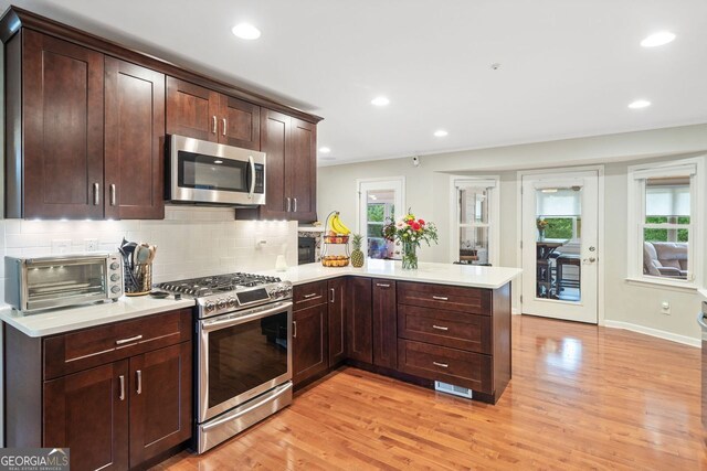 3415 Trickum Rd, Woodstock, GA 30188 - kitchen with appliances with stainless steel finishes, a peninsula, light countertops, backsplash, and recessed lighting