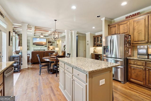 121 Ridge View Dr, Ball Ground, GA 30107 - kitchen with stainless steel appliances, ornamental molding, a kitchen island, open floor plan, and recessed lighting