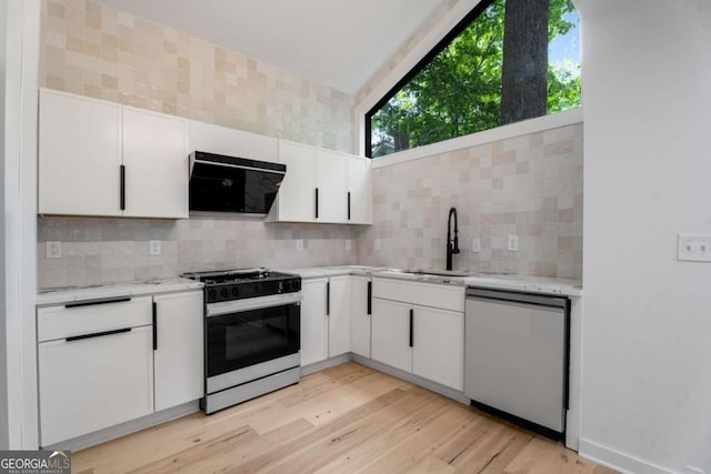 5020 Vallo Vista Ct, Atlanta, GA 30342 - kitchen featuring dishwasher, gas range oven, a sink, extractor fan, and backsplash