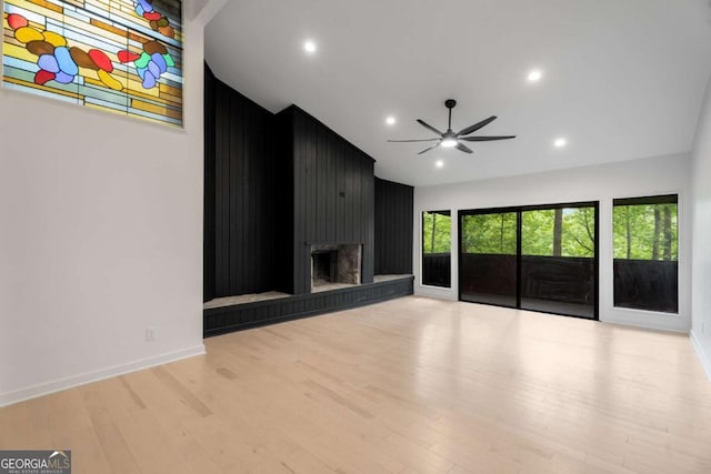 5020 Vallo Vista Ct, Atlanta, GA 30342 - unfurnished living room with wood finished floors, baseboards, ceiling fan, a large fireplace, and recessed lighting