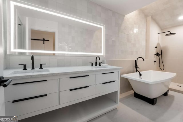 5020 Vallo Vista Ct, Atlanta, GA 30342 - full bathroom featuring double vanity, tile walls, backsplash, and a sink