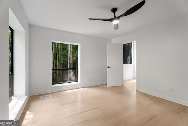 5020 Vallo Vista Ct, Atlanta, GA 30342 - unfurnished room featuring a ceiling fan, baseboards, visible vents, and light wood-style floors