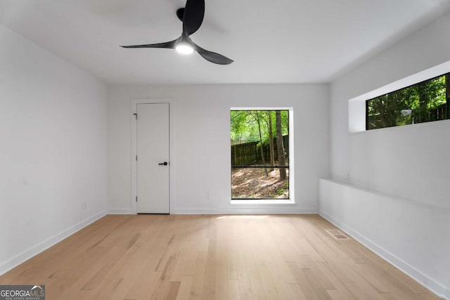 5020 Vallo Vista Ct, Atlanta, GA 30342 - spare room featuring baseboards, ceiling fan, light wood-style floors, and visible vents