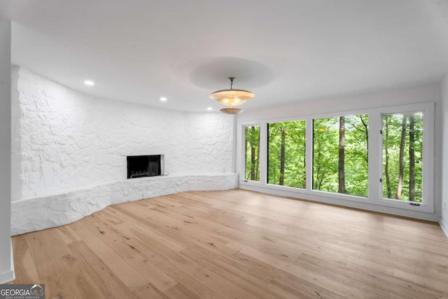 5020 Vallo Vista Ct, Atlanta, GA 30342 - unfurnished living room with recessed lighting, a stone fireplace, and wood finished floors