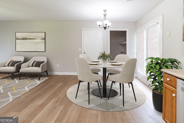 67 Jennifer Ln, Rydal, GA 30171 - dining area with a textured ceiling, light wood-type flooring, baseboards, and a notable chandelier