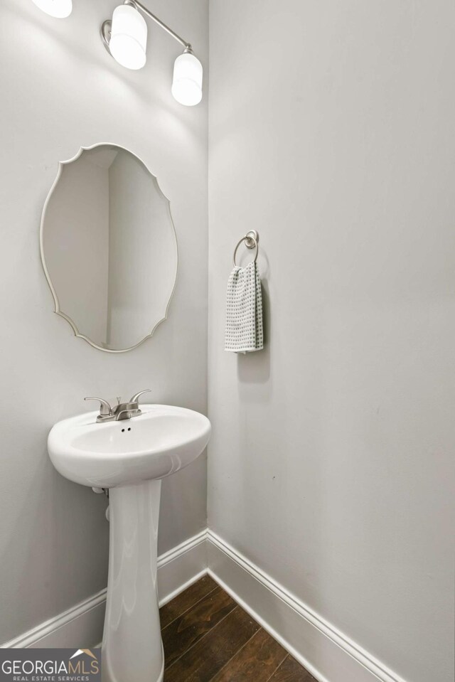 bathroom featuring baseboards and wood finished floors