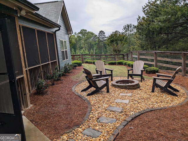 1202 Shiva Blvd, Winder, GA 30680 - view of yard featuring a fire pit, fence, and a sunroom