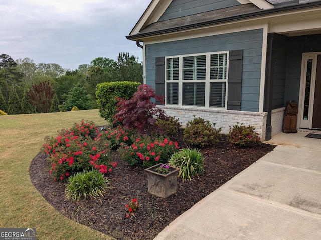 1202 Shiva Blvd, Winder, GA 30680 - view of home's exterior featuring a yard and brick siding