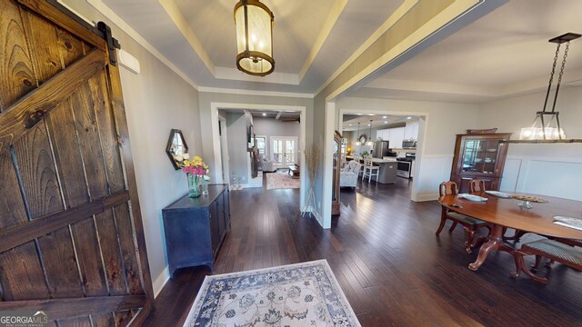 1202 Shiva Blvd, Winder, GA 30680 - entryway with a tray ceiling, dark wood-type flooring, baseboards, and a barn door