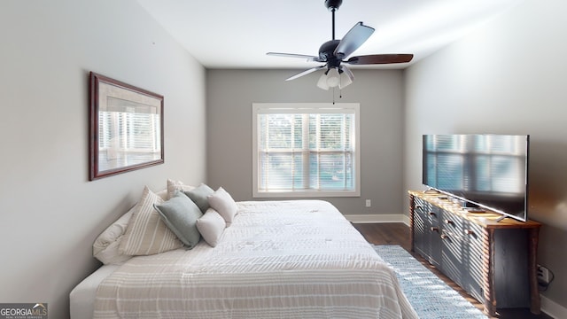 1202 Shiva Blvd, Winder, GA 30680 - bedroom featuring dark wood-style floors, baseboards, and a ceiling fan