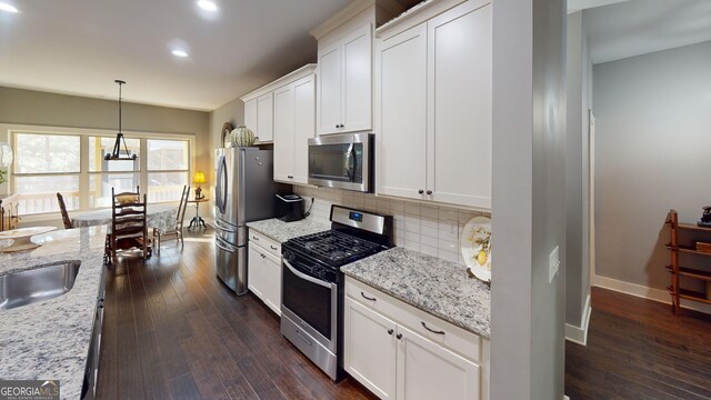 1202 Shiva Blvd, Winder, GA 30680 - kitchen featuring stainless steel appliances, tasteful backsplash, dark wood-style floors, baseboards, and recessed lighting