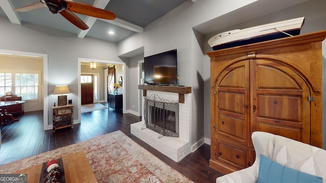 1202 Shiva Blvd, Winder, GA 30680 - living area with a ceiling fan, dark wood finished floors, beam ceiling, baseboards, and a fireplace