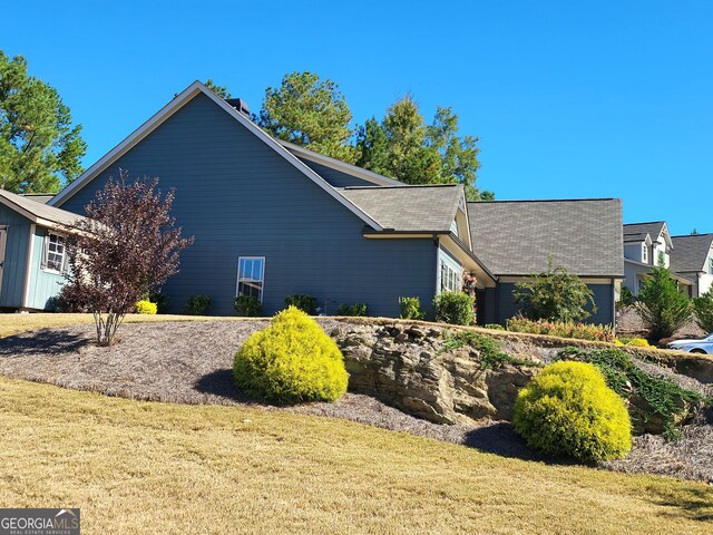 1202 Shiva Blvd, Winder, GA 30680 - view of home's exterior with a lawn and a shingled roof