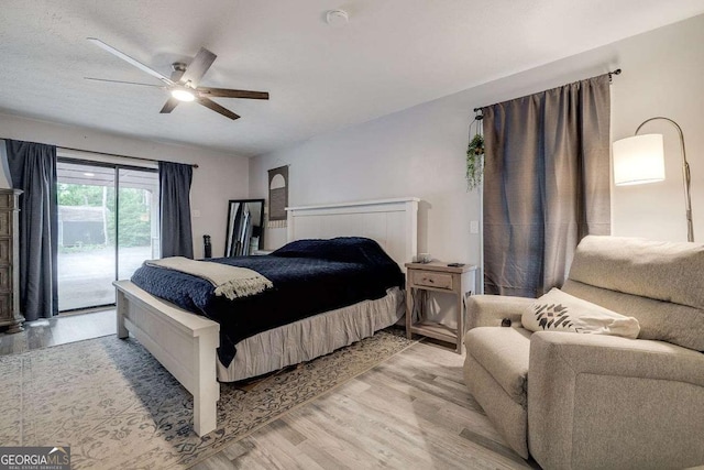 bedroom featuring access to outside, light wood-style flooring, and ceiling fan