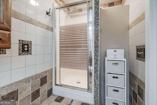 full bathroom featuring tile walls and a stall shower