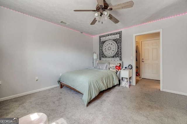 bedroom featuring carpet flooring, ceiling fan, a textured ceiling, baseboards, and visible vents