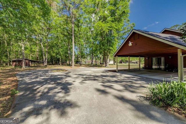 exterior space with driveway and an attached carport