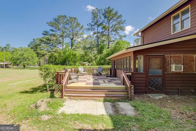 wooden deck featuring a wall mounted AC and a yard