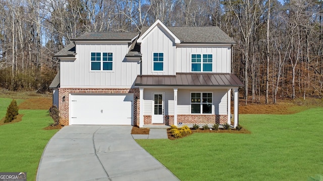 view of front of property with an attached garage, a front lawn, brick siding, board and batten siding, and driveway