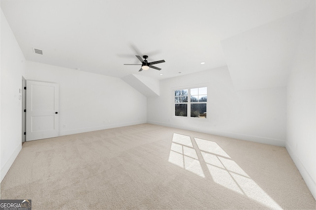 additional living space with visible vents, carpet flooring, baseboards, and ceiling fan
