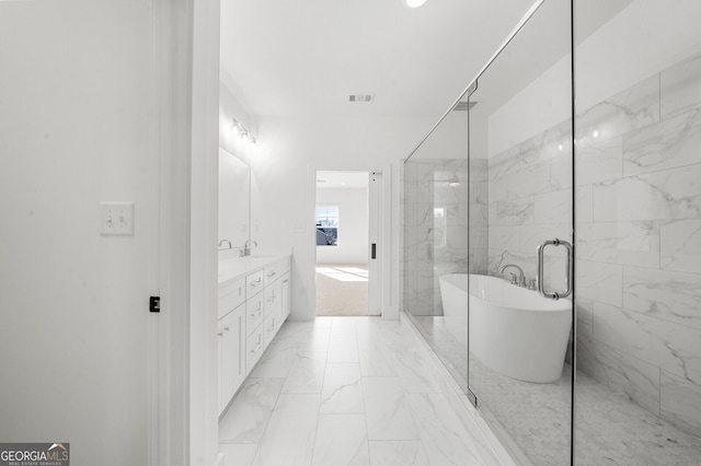 bathroom with double vanity, visible vents, a freestanding tub, marble finish floor, and a shower with door