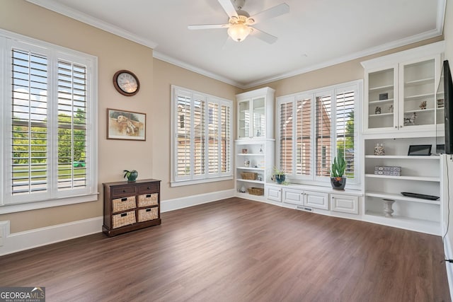 interior space featuring ceiling fan, visible vents, baseboards, dark wood-style floors, and ornamental molding