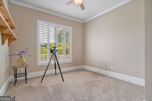 spare room featuring crown molding, a ceiling fan, baseboards, and carpet