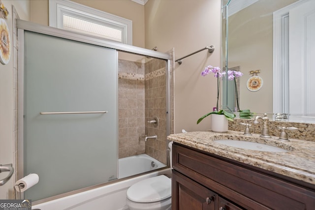 full bath featuring vanity, enclosed tub / shower combo, and toilet