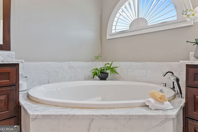 bathroom with a bath and vanity