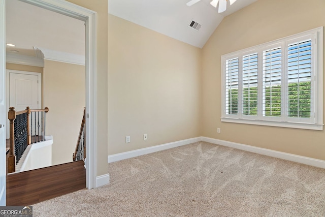 spare room with visible vents, lofted ceiling, baseboards, ceiling fan, and carpet flooring