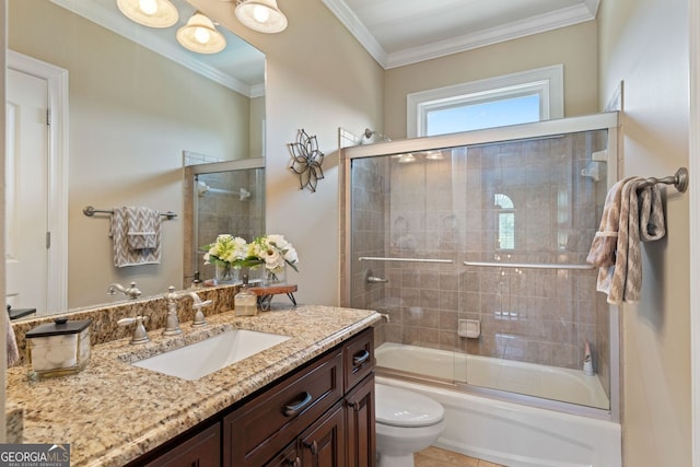 full bath with crown molding, vanity, bath / shower combo with glass door, and toilet