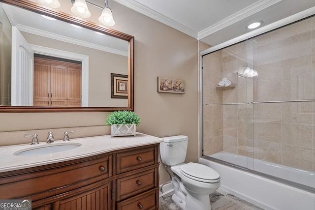bathroom with vanity, ornamental molding, toilet, and shower / bath combination with glass door