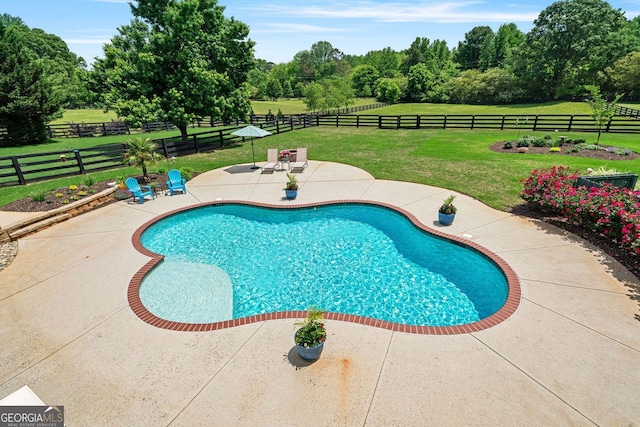 view of swimming pool featuring a yard, a fenced in pool, a fenced backyard, and a patio area