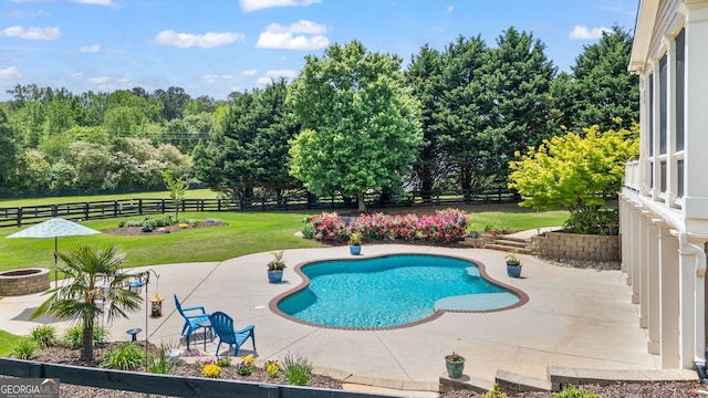 pool with a lawn, a fenced backyard, and a patio area