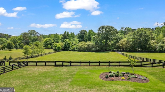 view of yard featuring fence and a rural view